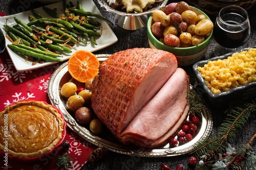 Fotografia, Obraz Honey Smoked Ham with sides and xmas desserts/ Christmas Holiday Dinner conept