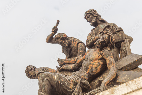 Close up of Ruined statue of Crucifixion of Jesus on a cross