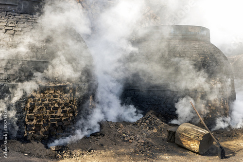 The production of charcoal in a traditional manner in the forest photo