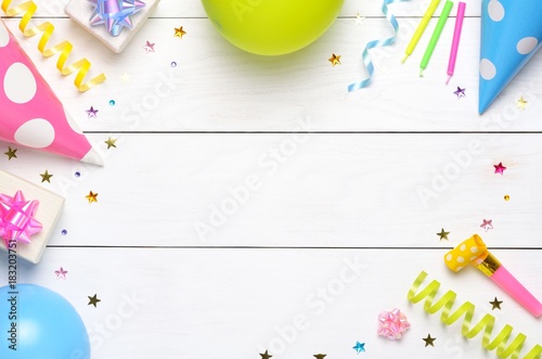 Decoration for the party on wooden white background. Top view. Space for text.