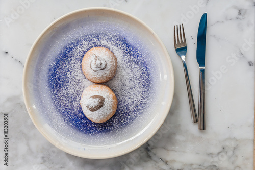 Top view of Bombolone is an Italian filled doughnut and is eaten as a snack food and dessert. photo