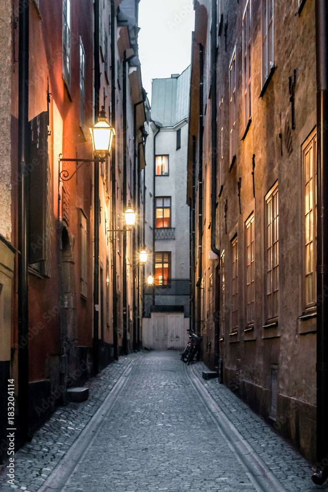 Fototapeta cityscape of empty small street in old town at dawn in Stockholm, Sweden