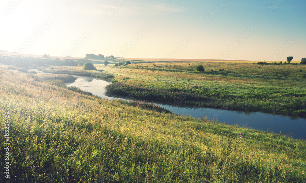 Sunny summer landscape.River Upa in Tula region, Russia.Meadows and fields at sunrise.Beautiful view. 