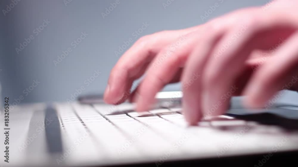 Businessman typing on a laptop and using a smartphone for work Businessman typing on a laptop and using a smartphone for work
