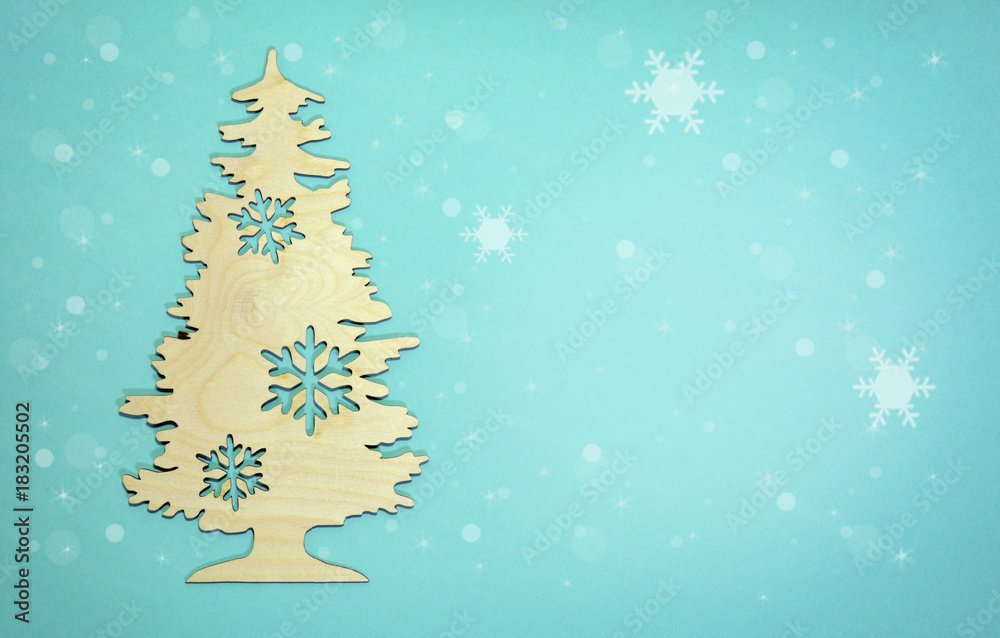 New Year background Christmas tree with snow flakes on light blue New Year background Christmas tree with snow flakes on light blue