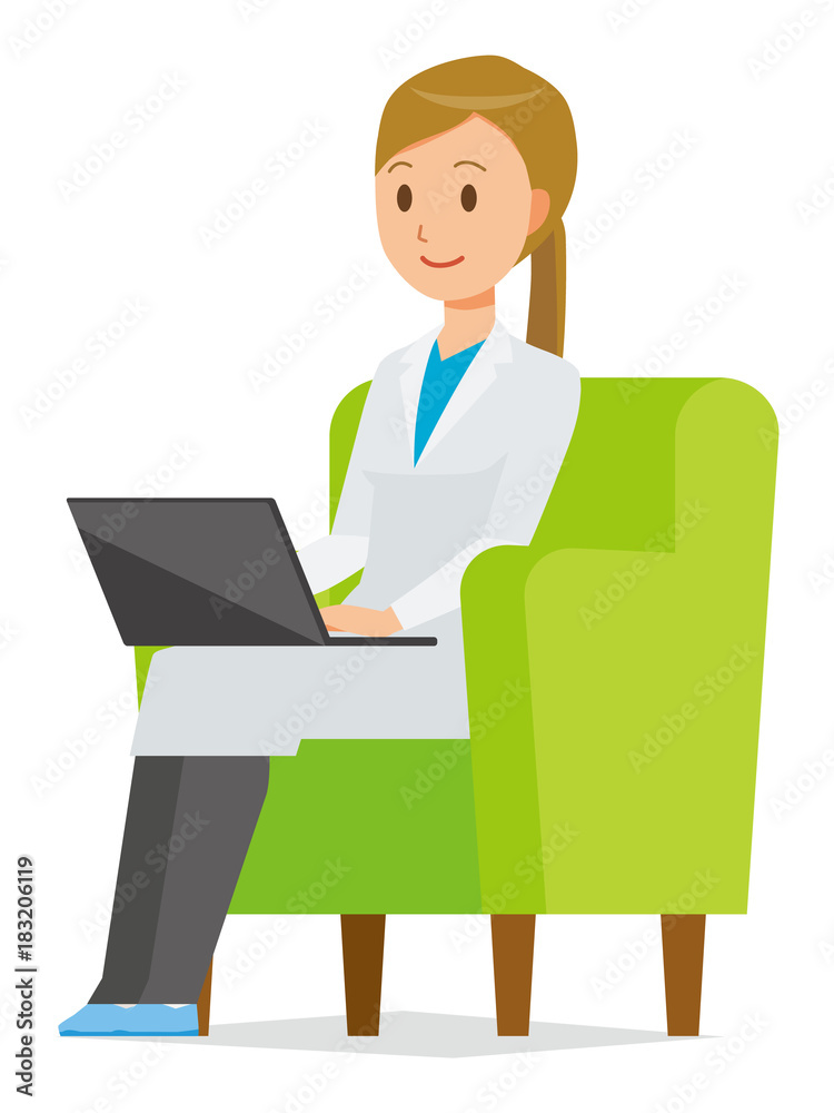 A woman doctor wearing a white suit sits on a sofa and is operating a laptop computer