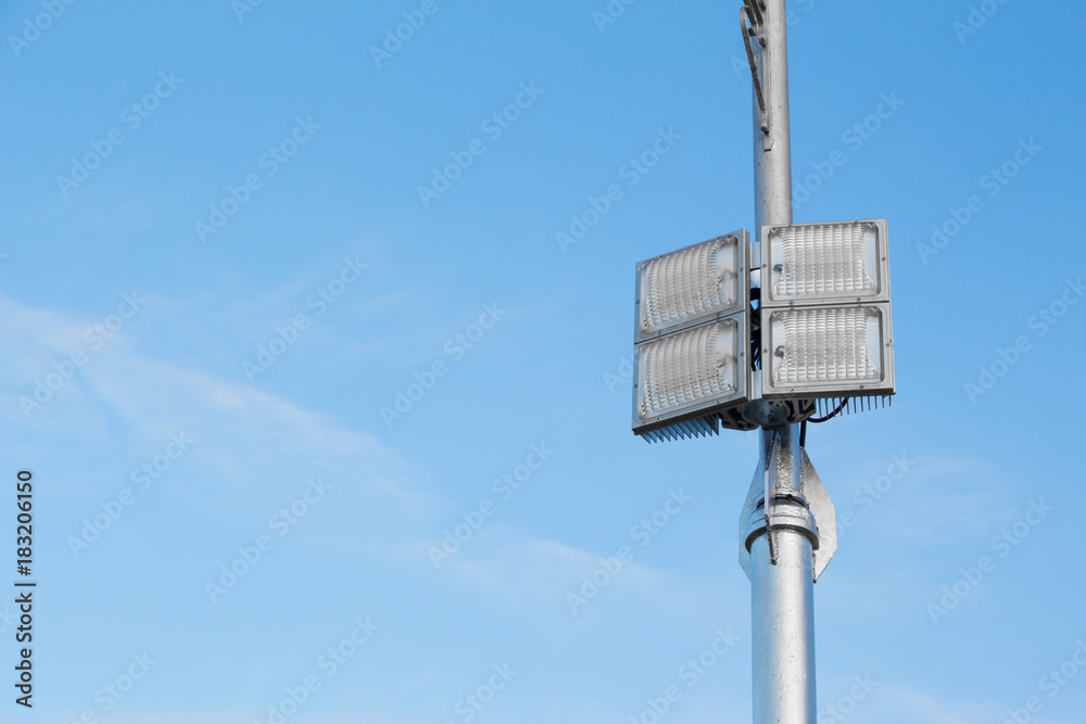 Silver lamp post with a light LED bulb on the right side and background sky. Silver lamp post with a light LED bulb on the right side and background sky.