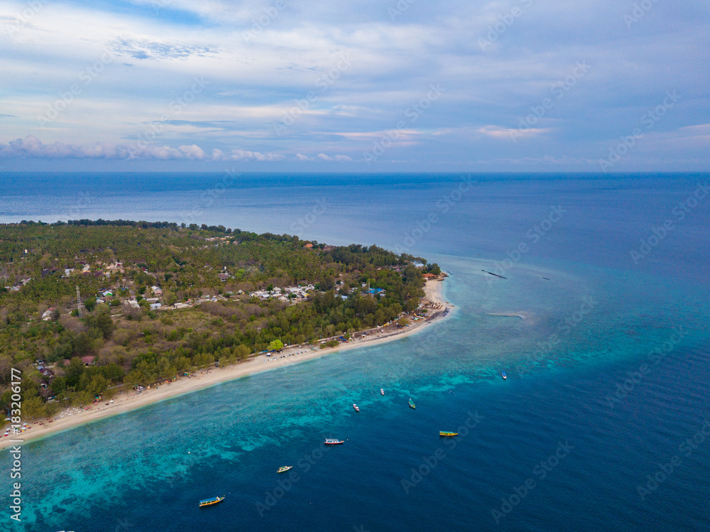 Aerial view of Gili Trawangan Island coastline with boats and buildings, West Nusa Tenggara, Indonesia