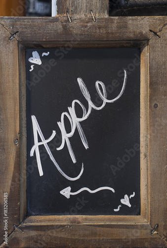 Fotografie Close-up of blackboard with word Apple written on it with an arrow showing to