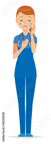 A woman nurse wearing a blue scrub is crying