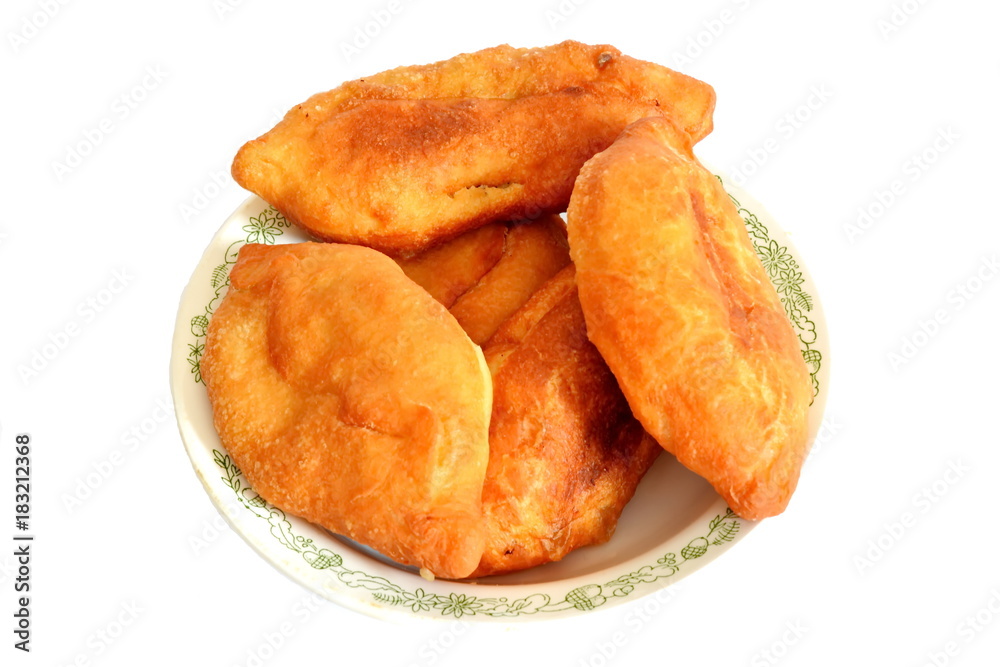 russian fried traditional homemade golden pie of dough and meat on pattern dish isolated. White background
