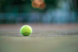 Tennis ball on green coating. Healthy lifestyle concept. Place for text.