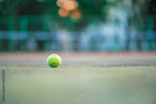 Tennis ball on green coating. Healthy lifestyle concept. Place for text.