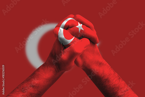 Clasped hands patterned with the Turkey flag, multi purpose concept - isolated on flag background