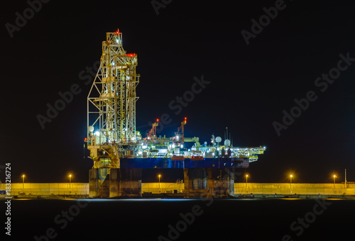 drilling platform at night in the port