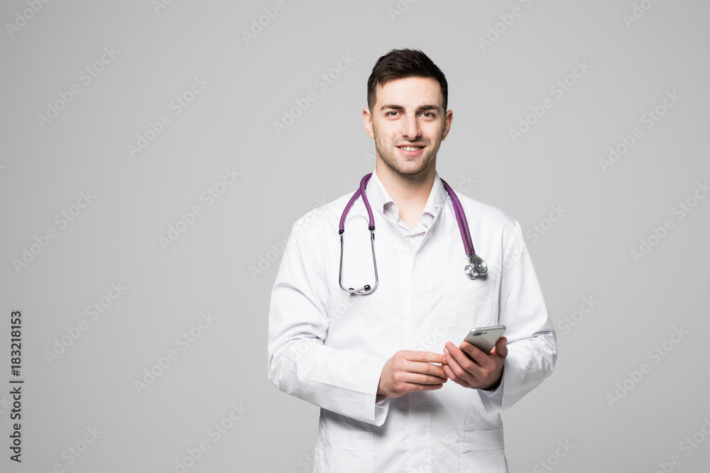Happy doctor man texting on smart phone isolated on a white background Happy doctor man texting on smart phone isolated on a white background