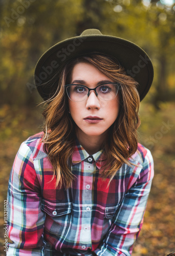  Pretty girl with glasses and hat  closeup portrait outdoors in the green park in autumn © Nenad