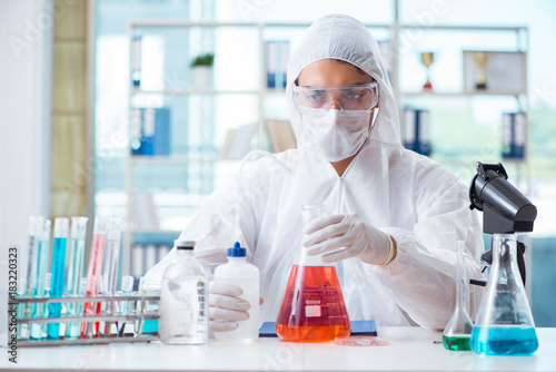 Chemist working in the laboratory with hazardous chemicals