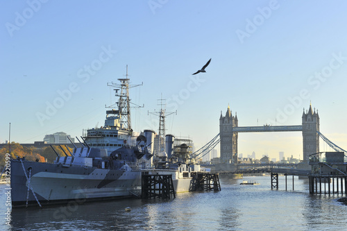 London Tower Bridge on the background of a warship on the river Thames