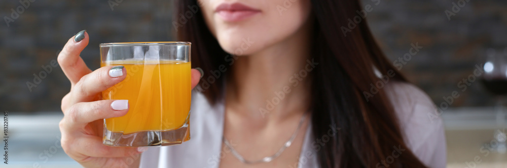 beautiful woman in the kitchen eating a juice beautiful woman in the kitchen eating a juice