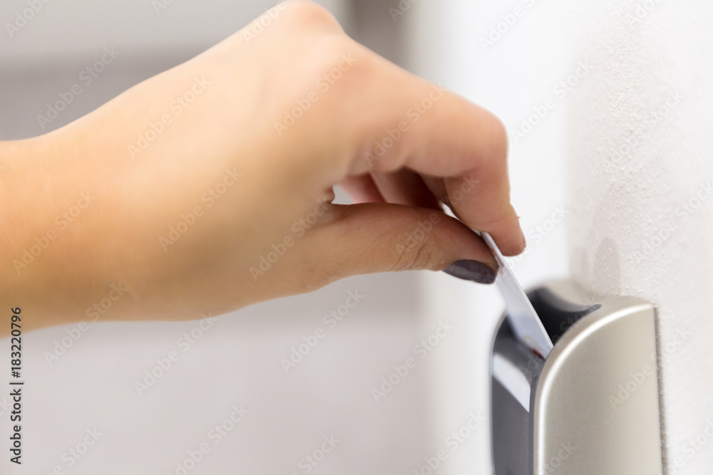 Close up of female hand opening keycard electronic lock