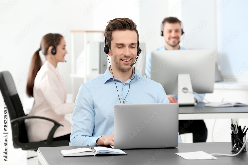 Male consulting manager with headset in office Male consulting manager with headset in office