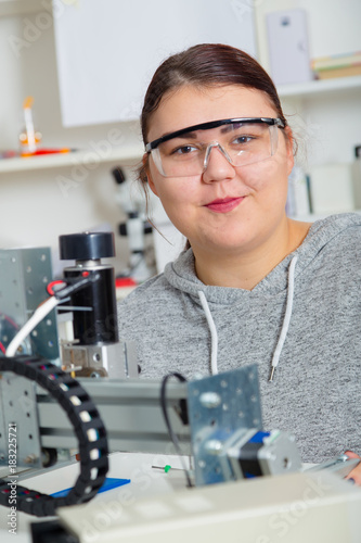 Female Apprentice working on CNC machinery.