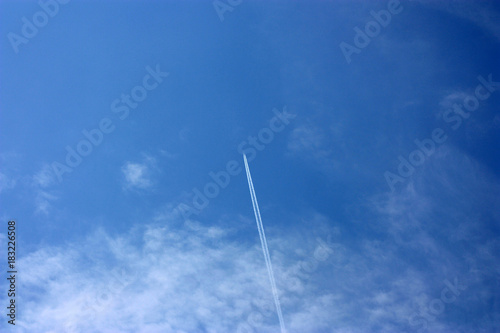 inverse track from airplane on the cloudy sky. White clouds on the blue sky background