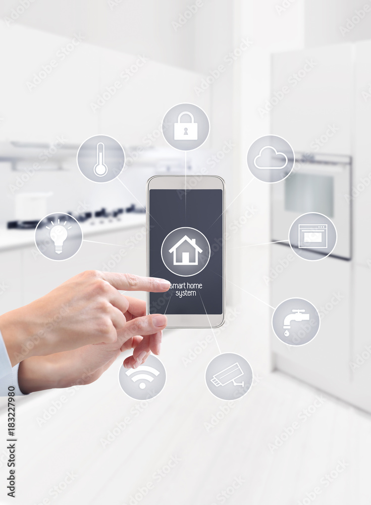 Fototapeta premium home automation hand touch smart phone screen with symbols on kitchen blurred background