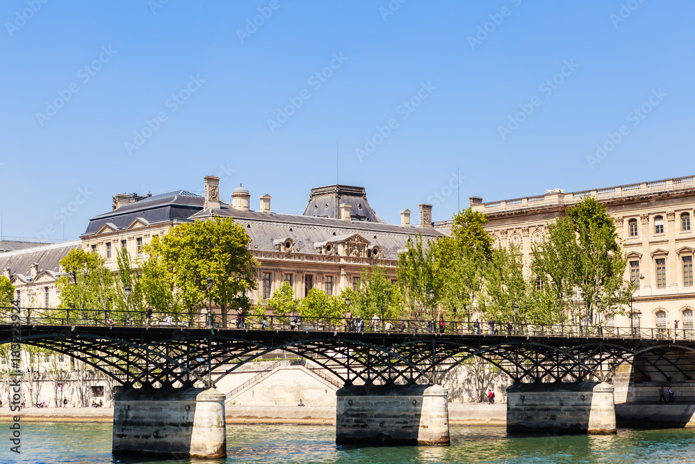 Naklejka premium Ponts the Arts, view fragment of Louvre buildings of Square Courtyard (Cour Carree) and South facade. Paris, France