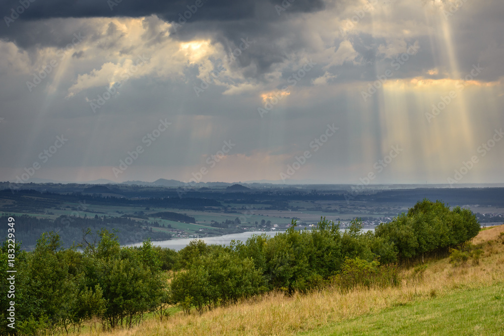 Rays of light pass through the clouds, mountain landscape. Pieniny, Poland.