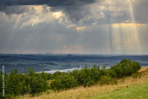 Rays of light pass through the clouds  mountain landscape. Pieniny  Poland.