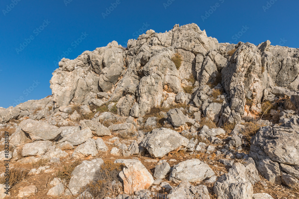 Stony landscape with trees of the Tsambika mountain on the Rhodes Island, Greece Stony landscape with trees of the Tsambika mountain on the Rhodes Island, Greece