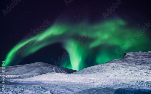 The polar arctic Northern lights aurora borealis sky star in Norway Svalbard in Longyearbyen city the moon mountains