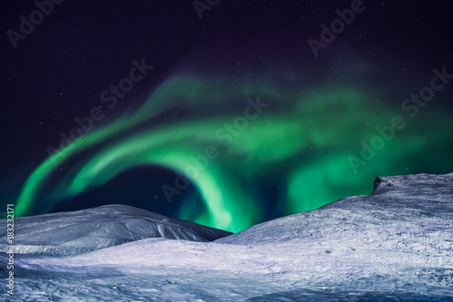 Fototapeta Naklejka Na Ścianę i Meble -  The polar arctic Northern lights aurora borealis sky star in Norway Svalbard in Longyearbyen city the moon mountains