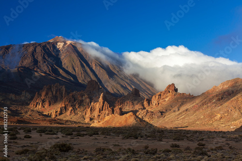 Teide volcano mountain in clouds on sunset in Taide park, Tenerife, Canary Islans, Spain photo