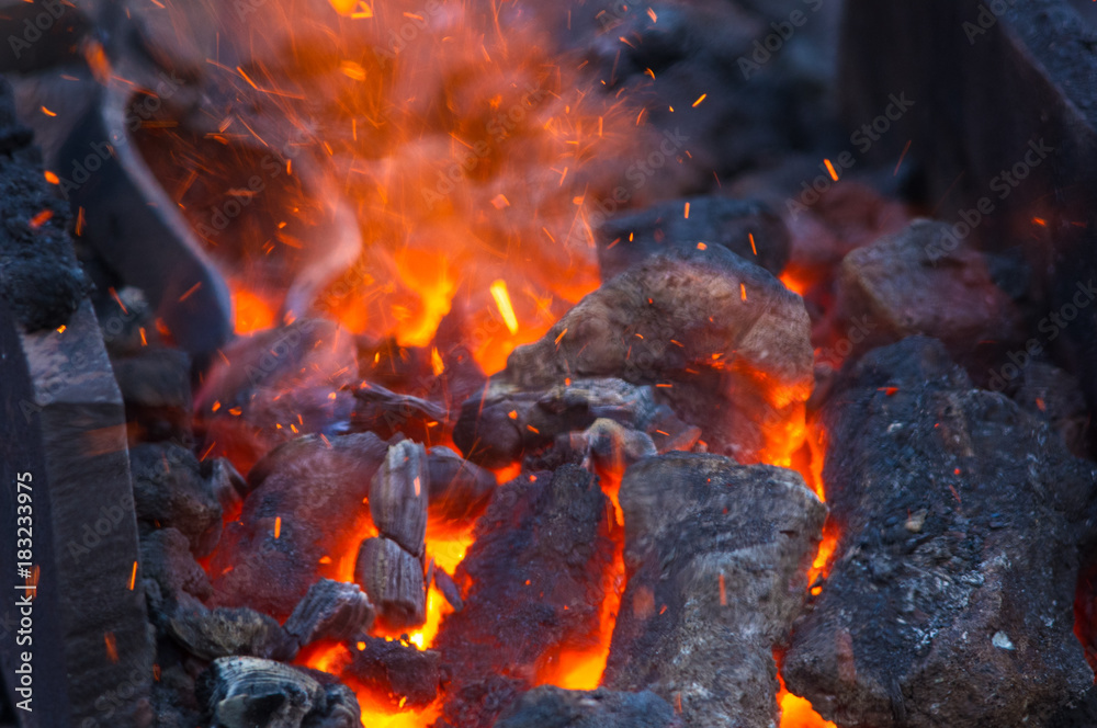 blacksmith furnace with burning coals, tools, and glowing hot metal workpieces blacksmith furnace with burning coals, tools, and glowing hot metal workpieces