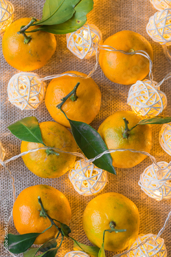 Tangerines and Christmas garlands glow