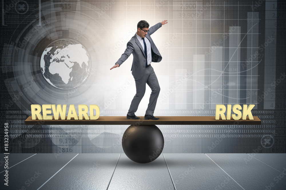 Businessman balancing between reward and risk business concept Stock ...