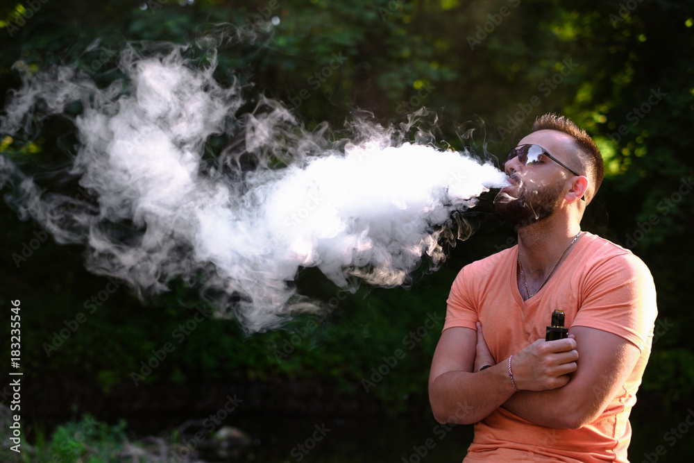 Men with beard smoke electronic cigarette outdoor Men with beard smoke electronic cigarette outdoor