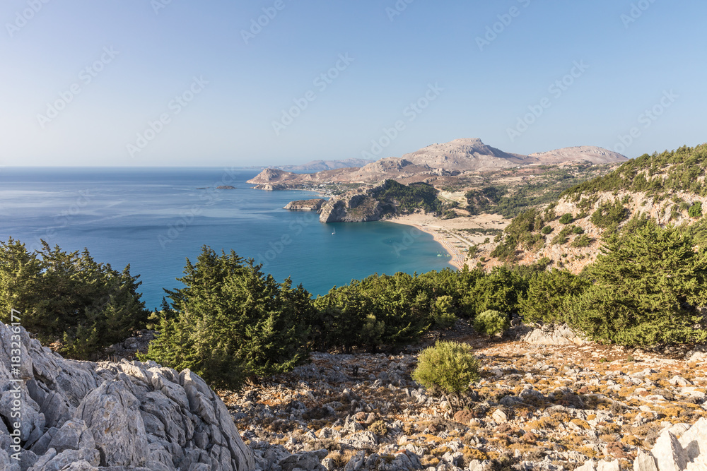 Stony landscape and a view of the Tsambika beach on the Rhodes Island, Greece