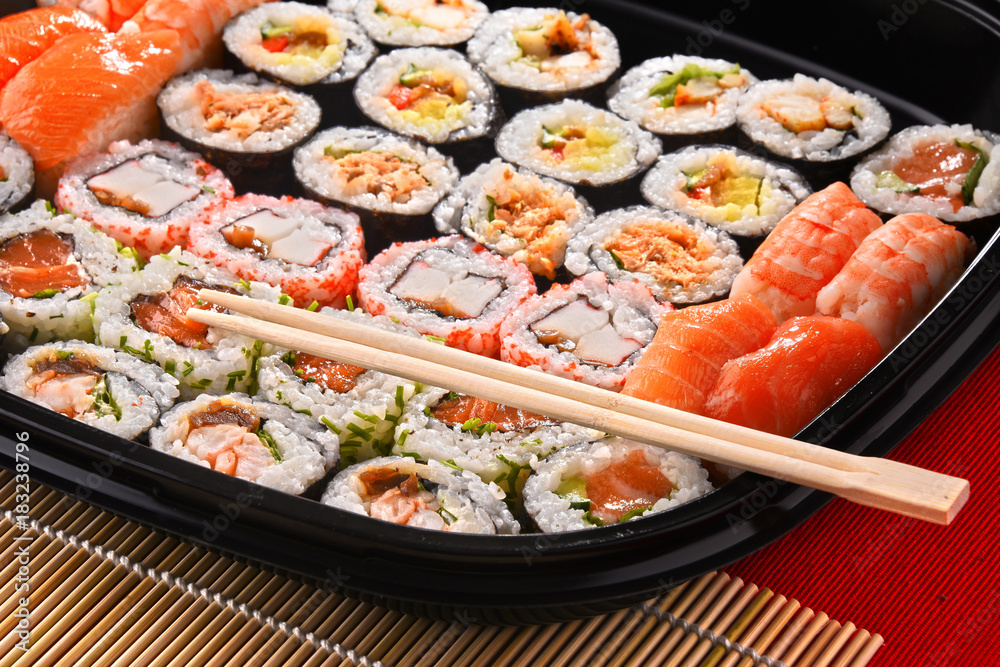 Composition with assorted sushi rolls and bowls of spices Composition with assorted sushi rolls and bowls of spices
