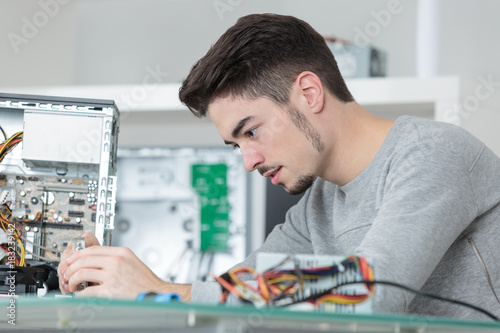 Young computer technician at work