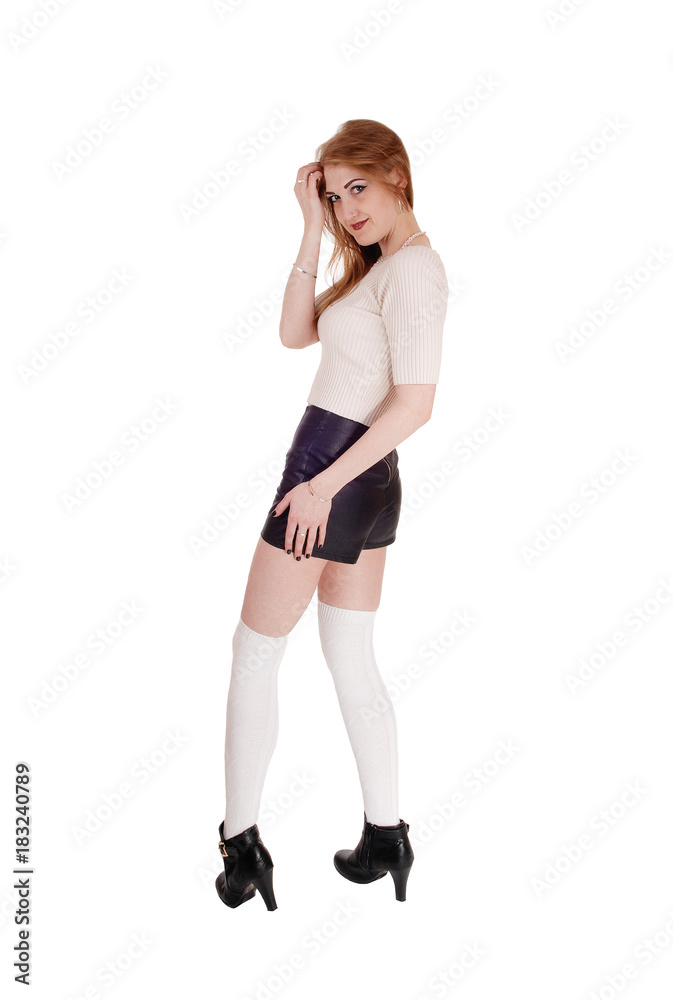 Woman standing in leather shorts looking back Woman standing in leather shorts looking back