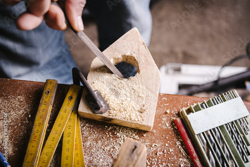 Amateur carpenter uses a wood file photo