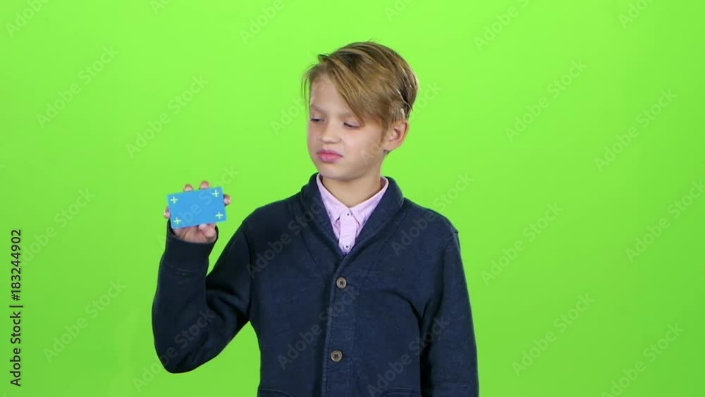 Teenager looking for a credit card and shows cool on the green screen. Slow motion Teenager looking for a credit card and shows cool on the green screen. Slow motion