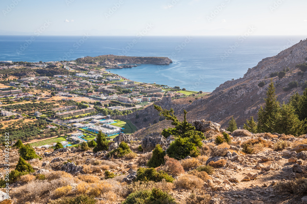 Stony landscape of Tsambika mountain and a view of Kolymbia, a small resort on the Rhodes Island, Greece.