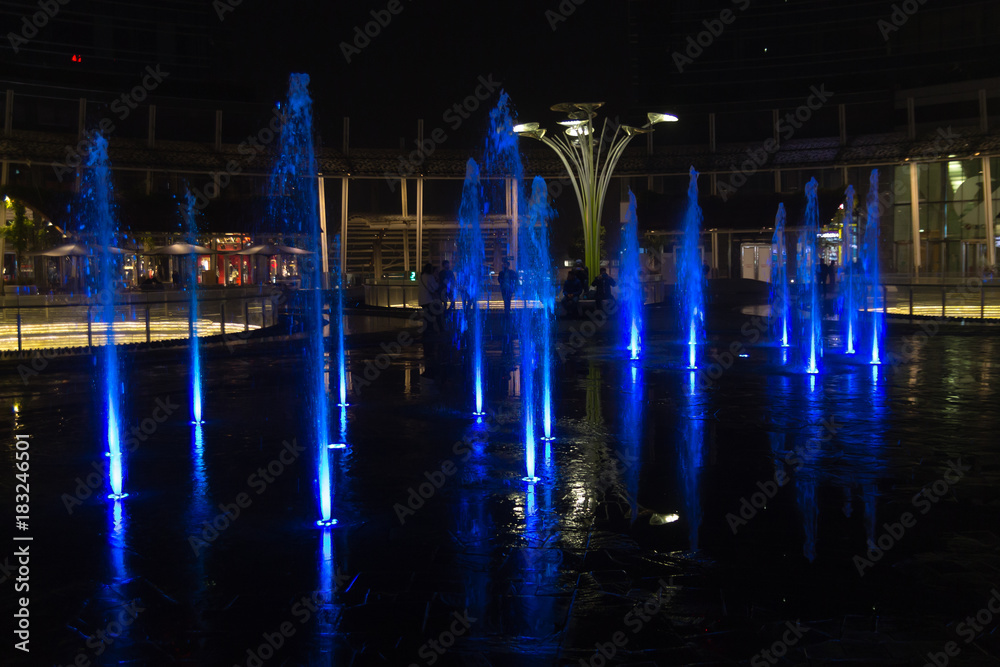 Milan, Italy, Financial district night view. Illuminated water fountains