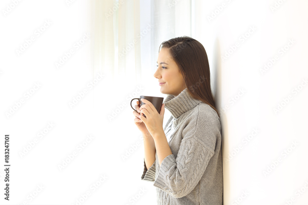Woman looking away holding a coffee mug Woman looking away holding a coffee mug