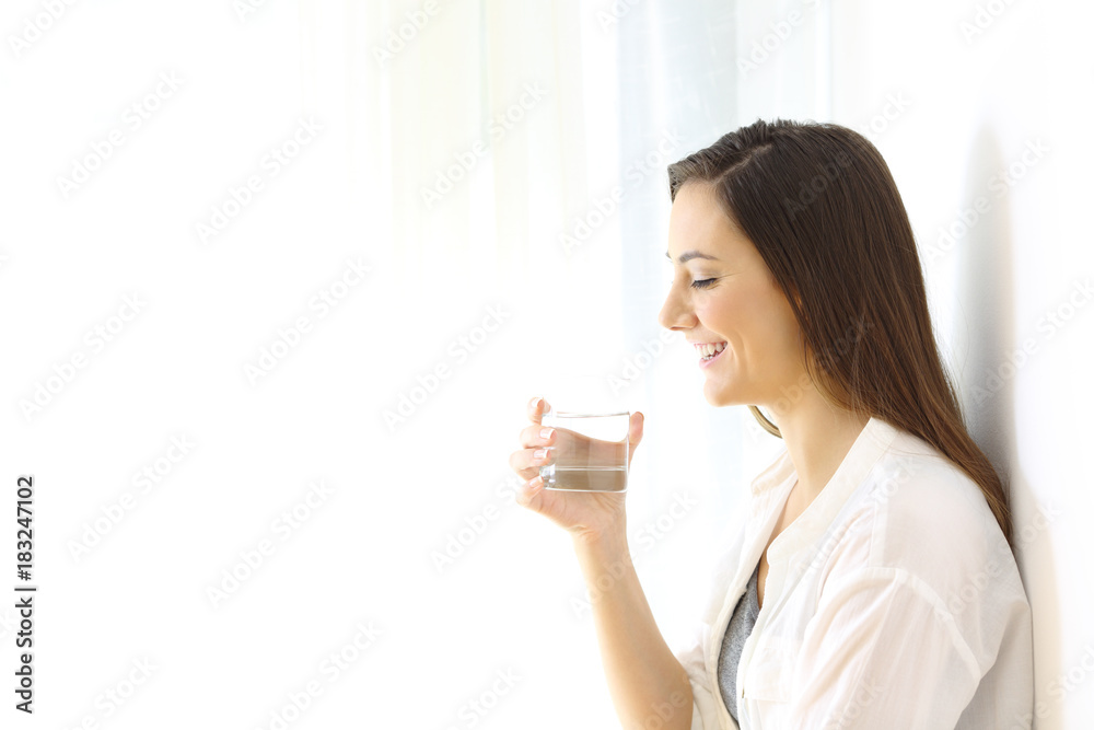 Woman holding a glass of water isolated at side Woman holding a glass of water isolated at side